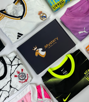 An example of our Mystery Football Shirt Box from Mystery Jersey King. In the image there is a box as well as various football shirts from different clubs