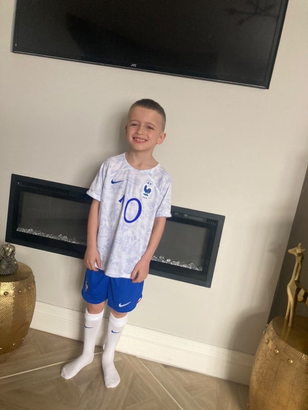 Young MJK customer wearing a genuine France away shirt from a Kids' Mystery Football Shirt Box