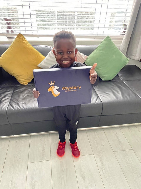 Young MJK customer holding up his Mystery Jersey King box