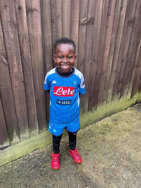 Young MJK customer beaming in a full Napoli kit