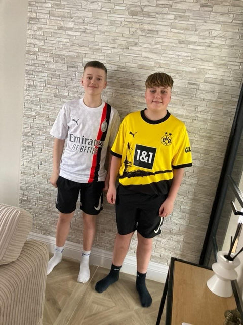 Two young MJK customers in AC Milan and Borussia Dortmund shirts