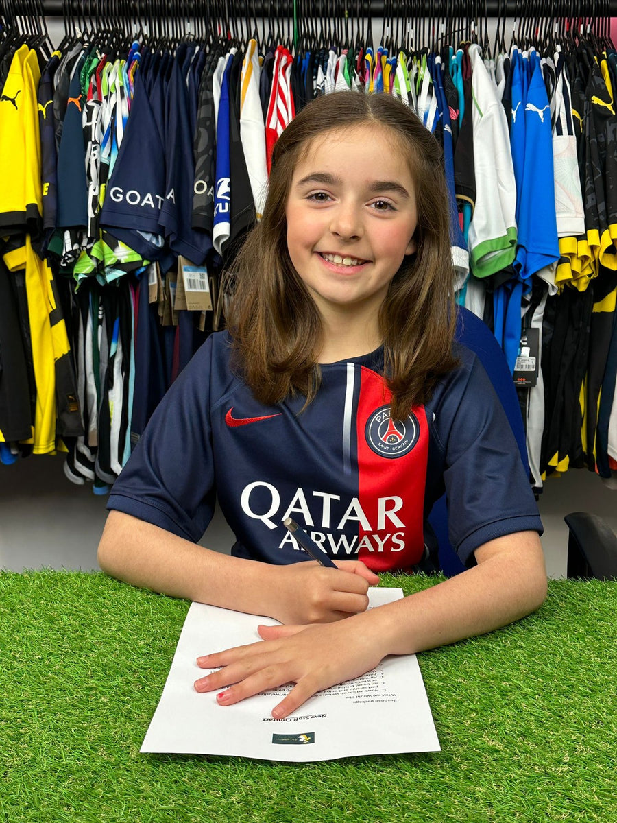 Young fan smiling in a PSG shirt from a Kids' Mystery Football Shirt Box