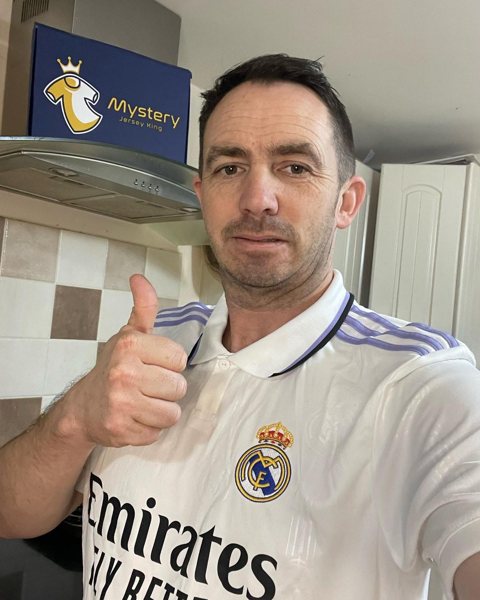 MJK customer giving a thumbs up in a Real Madrid shirt from his mystery box