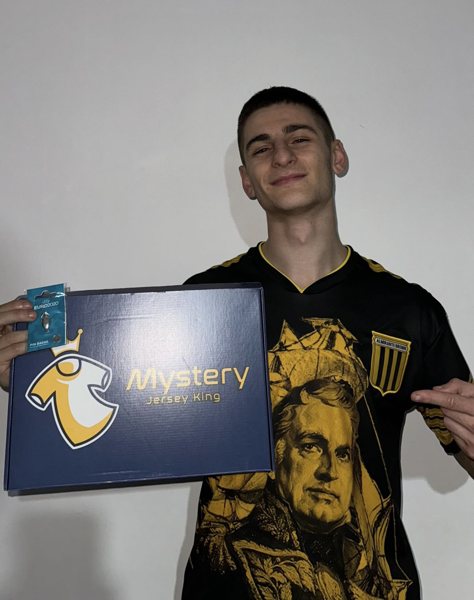 MJK customer holding his Mystery Jersey King box in a Club Almirante Brown shirt